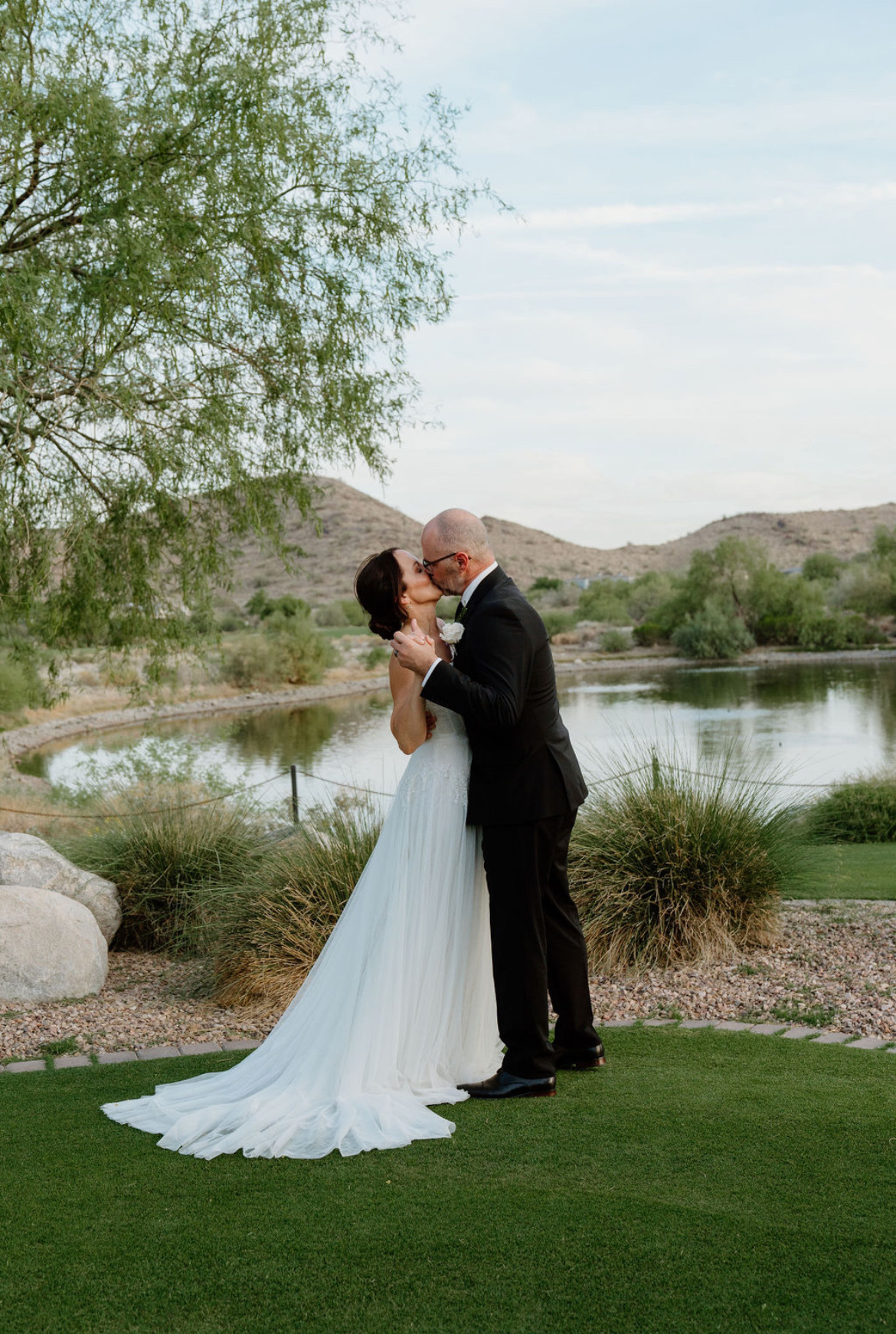 A married couple kisses on their wedding day after using XO Marriage resources